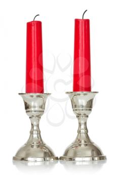 silver plated candlesticks with red candles on white background