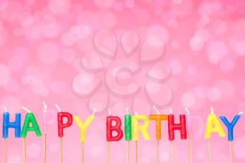 Happy birthday candles on the festive  pink  background