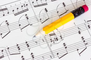 Sheet of musical notes with yellow pencil
