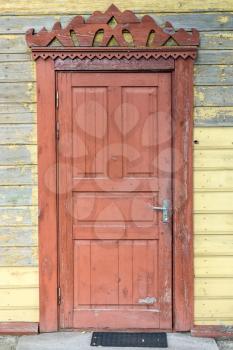 Old brown door in a wooden building