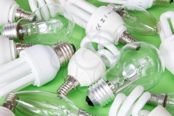 Collection of different kind of lightbulbs on green background 