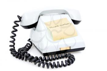 White telephone with sticky note for phone number 