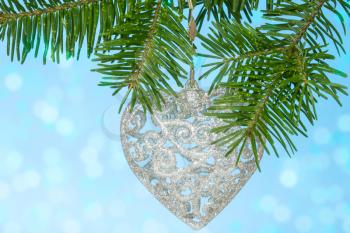 Christmas silver heart on the fir branch 