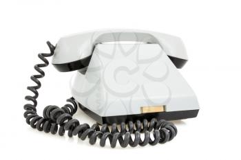 Old fashioned telephone over a white background