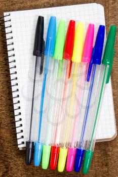 Royalty Free Photo of Pens and a Spiral Notebook