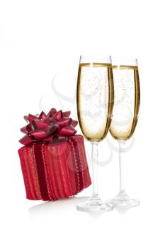 Glasses of champagne and a luxury gift box on the white background