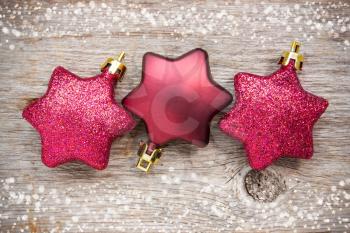 Christmas star   baubles on the wooden background