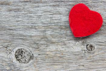 Background in the style of Valentine's Day. Red heart on a wooden background 