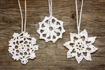 Royalty Free Photo of Crocheted Christmas Ornaments on Wood