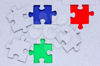 Jigsaw puzzle with different colored pieces signifying concepts of diversity, individuality and community 