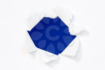 Hole in a paper with blue background inside 