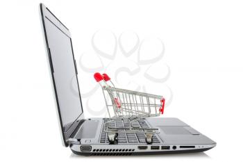 E-commerce. Shopping cart on laptop over a white background