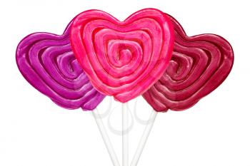 Three heart-shaped lollipops isolated on white background
