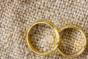 Two golden wedding rings on the burlap