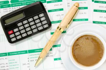 Calculator and coffee cup  in an environment of financial calculations 
