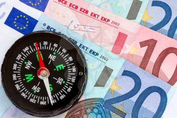 Euro money and compass showing financial success 