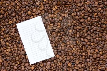 Empty list on the background coffee beans 