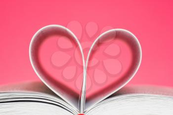 Pages of  book curved into a heart shape 