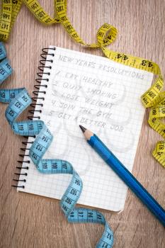 Measure tape and  notepad with New Year's resolutions