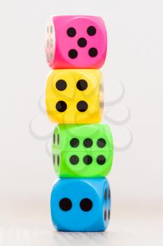 Stack of colorful dice, isolated on blurry background