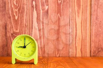 Alarm clock on the wood background. With copy-space for text
