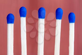 Row of match sticks with blue heads