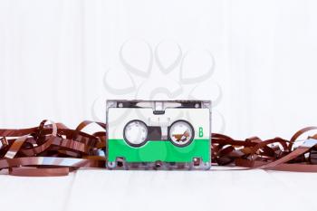 Audio cassette with subtracted out tape on wooden background