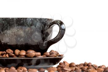 Coffee cup and beans over a  white background with copy space