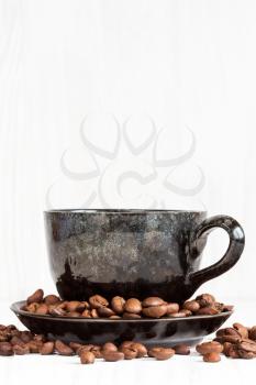 Cup of  coffee on a white wood  background with coffee beans