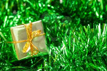 Christmas decoration with green  tinsel and little gift box