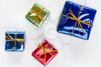 Close up of a shiny gift boxes on white wood background