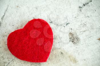 Decorative red heart on dirty background with copy-space