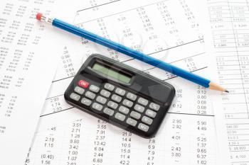 Accounting in process with calculator,pencil  and financial charts