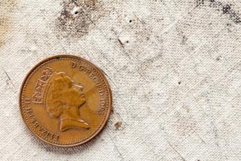 One penny on canvas background with copy - space