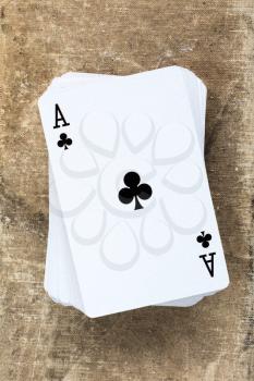 A poker card deck with black clover ace on the top