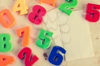 Colorful plastic numbers with empty cards for your text. Vintage image.