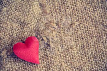 Red heart on gunny sackcloth texture background
