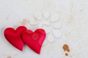 Two decorative hearts on stained paper with copy-space