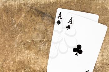 Pair of aces on canvas background with copy-space