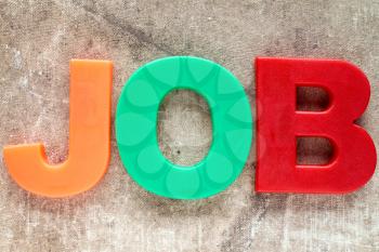 Job word spelled with colored plastic letters