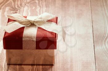 Gift box on brown wooden floor, christmas background