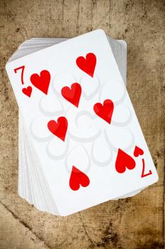 A poker card deck with seven of hearts on the top