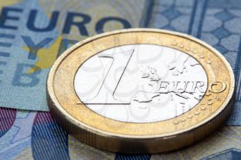 Macro photo of euro coin on twenty euro notes, shallow depth of field