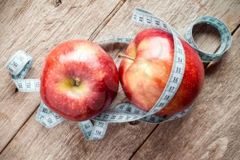 Red Apples with Measuring Tape on Wooden Background