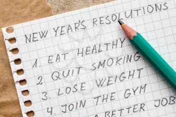 Pencil and list of resolutions for new year