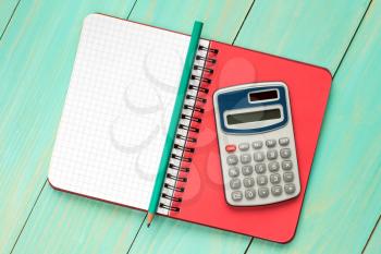   Electronic calculator and notebook with squared sheet for copy-space