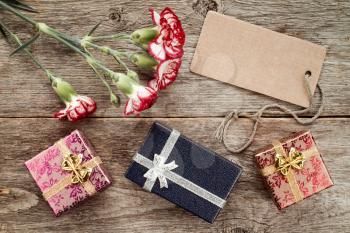 Three gift boxes,carnation and blank tag for your text