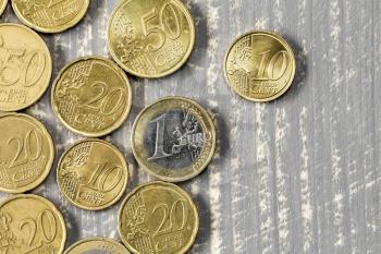 Euro coins on grey wooden table,top view shot for money background 