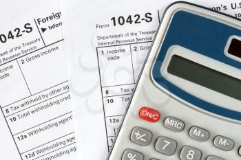 Filling out the form 1042-s which confirms the payment of the tax in the United States