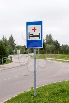Hospital or emergency sign next to the road